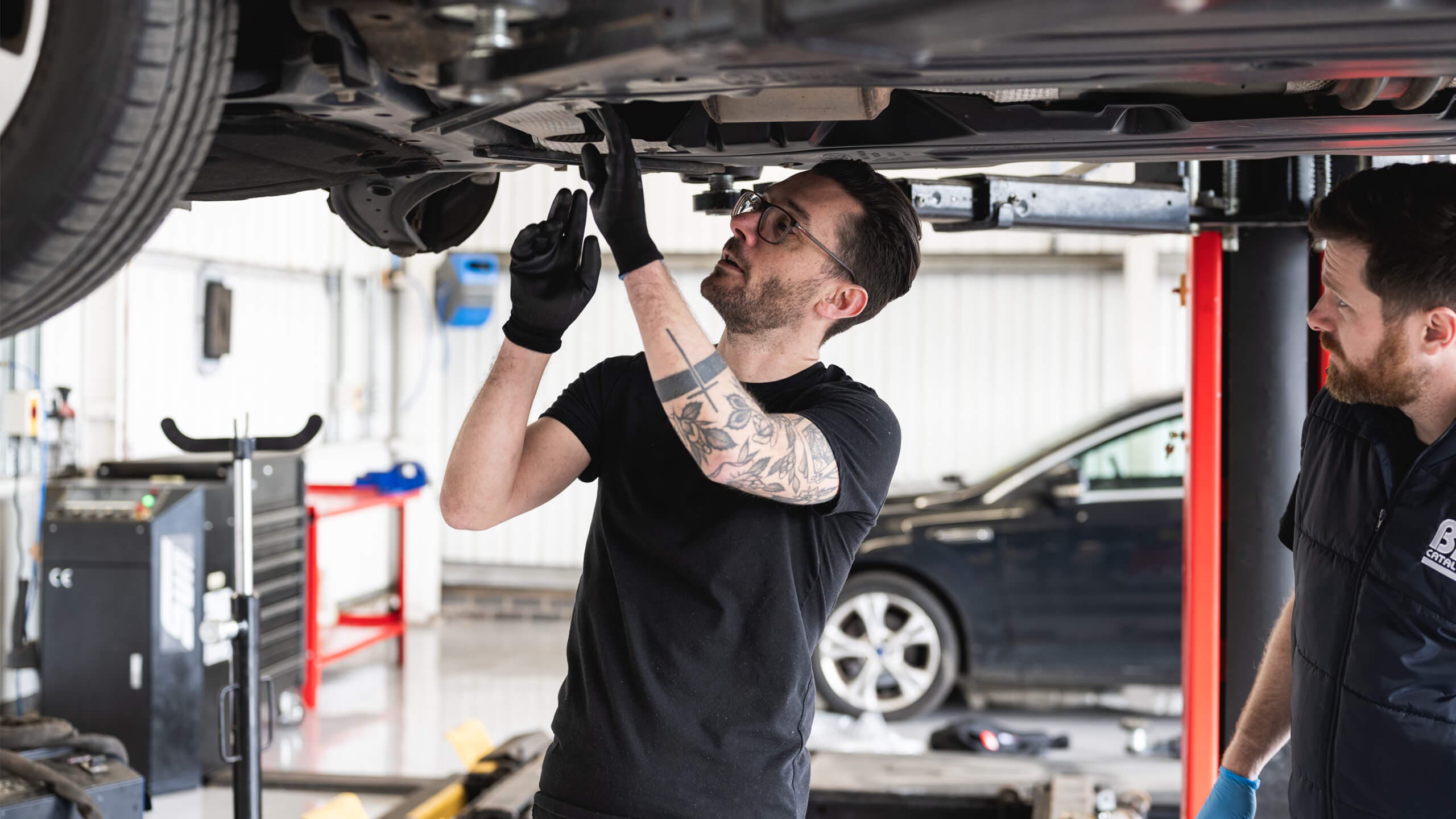 Mechanic working on the underside of a car