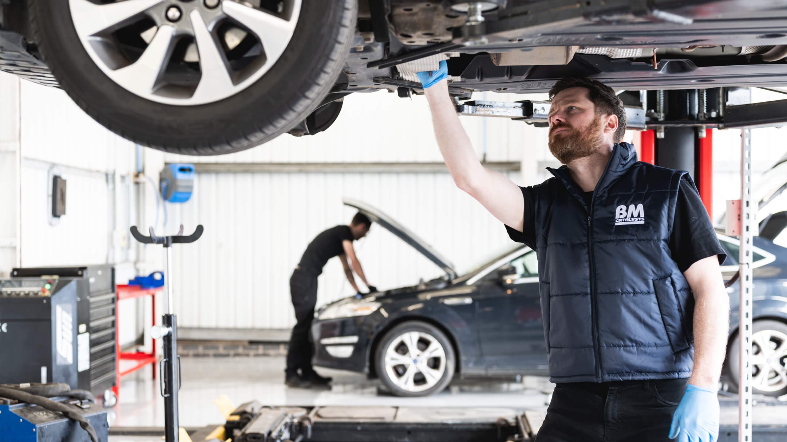 Mechanic working on a car exhaust